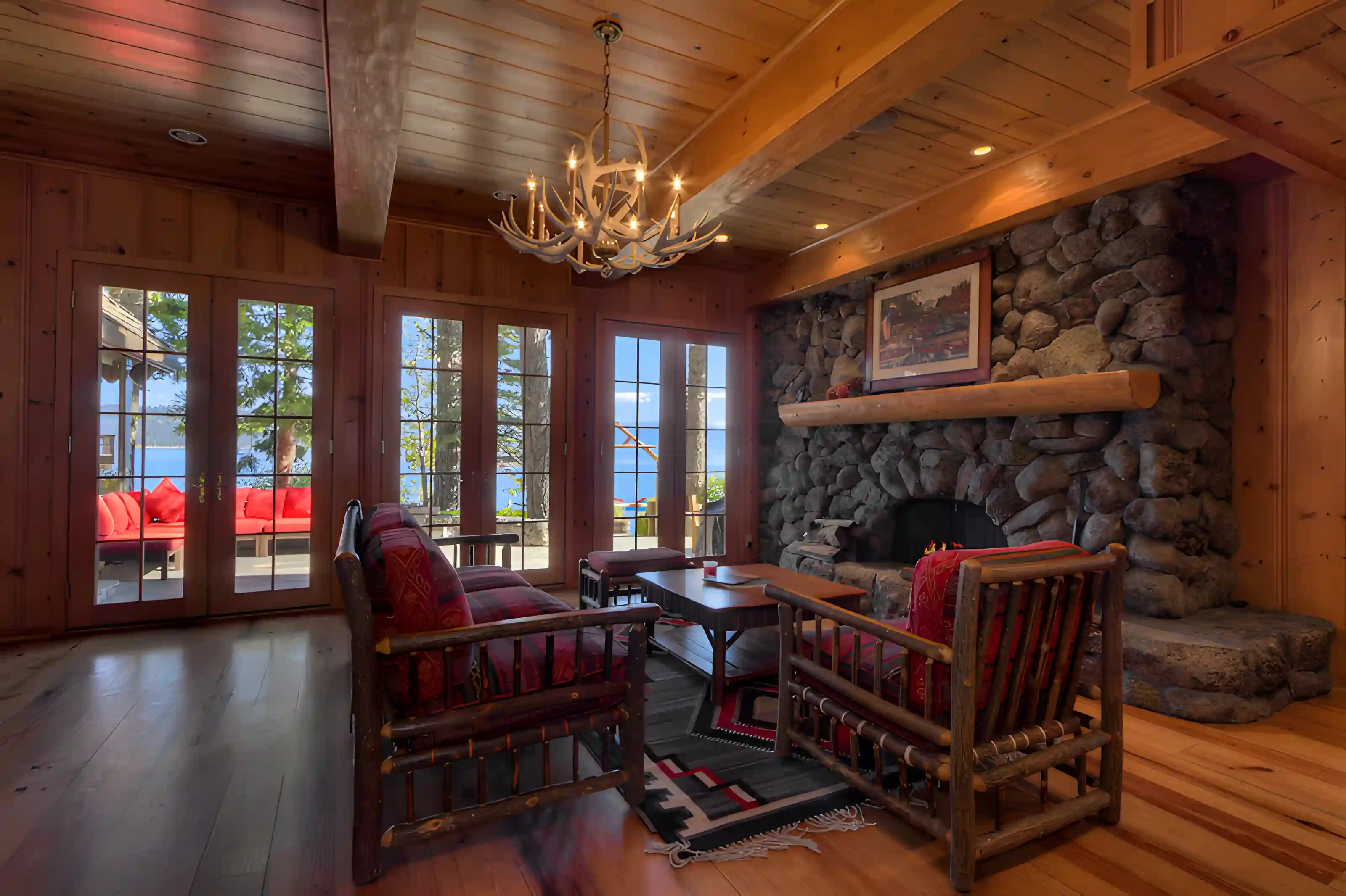Stone and timber lakefront residence with a broad terrace